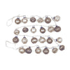 String of decorative christmas garland with mercury glass bulb ornaments on a white background.