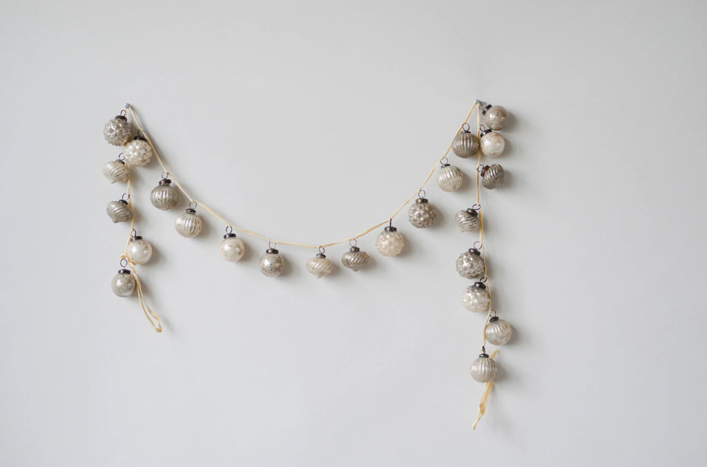Decorative garland with small balls on a light gray background