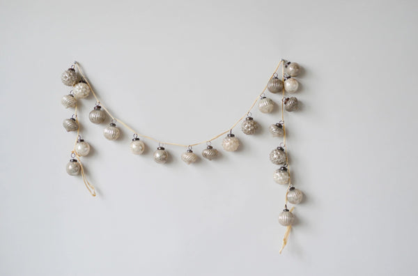 Decorative garland with small balls on a light gray background