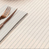 Table setting with a fork and knife on a striped cotton table cloth