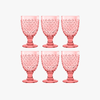 Set of six pink textured acrylic goblets on a white background