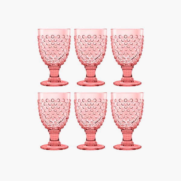 Set of six pink textured acrylic goblets on a white background