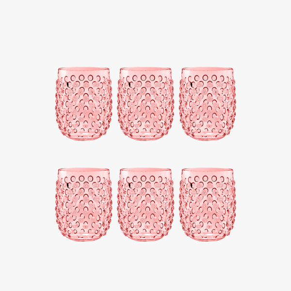Set of six pink textured stemless wine glasses on a white background