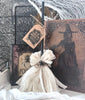 A rustic, primitive witch broom with a tag that reads 'OLD SALT' and 'WITCH BROOM'.