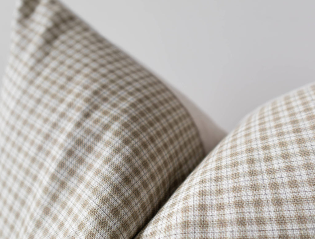 Close-up of a plaid patterned pillow on a neutral background_california casual home decorating
