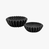 Two black ceramic bowls with textured edges on a white background