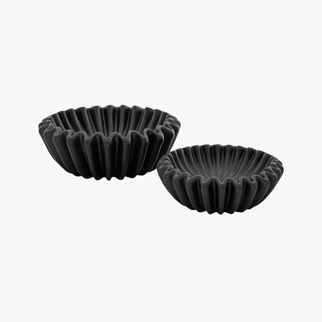 Two black ceramic bowls with textured edges on a white background