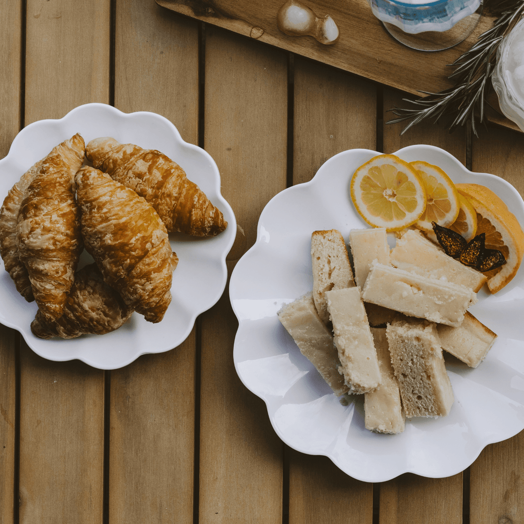 Two melamine trays of pastries on a wooden surface