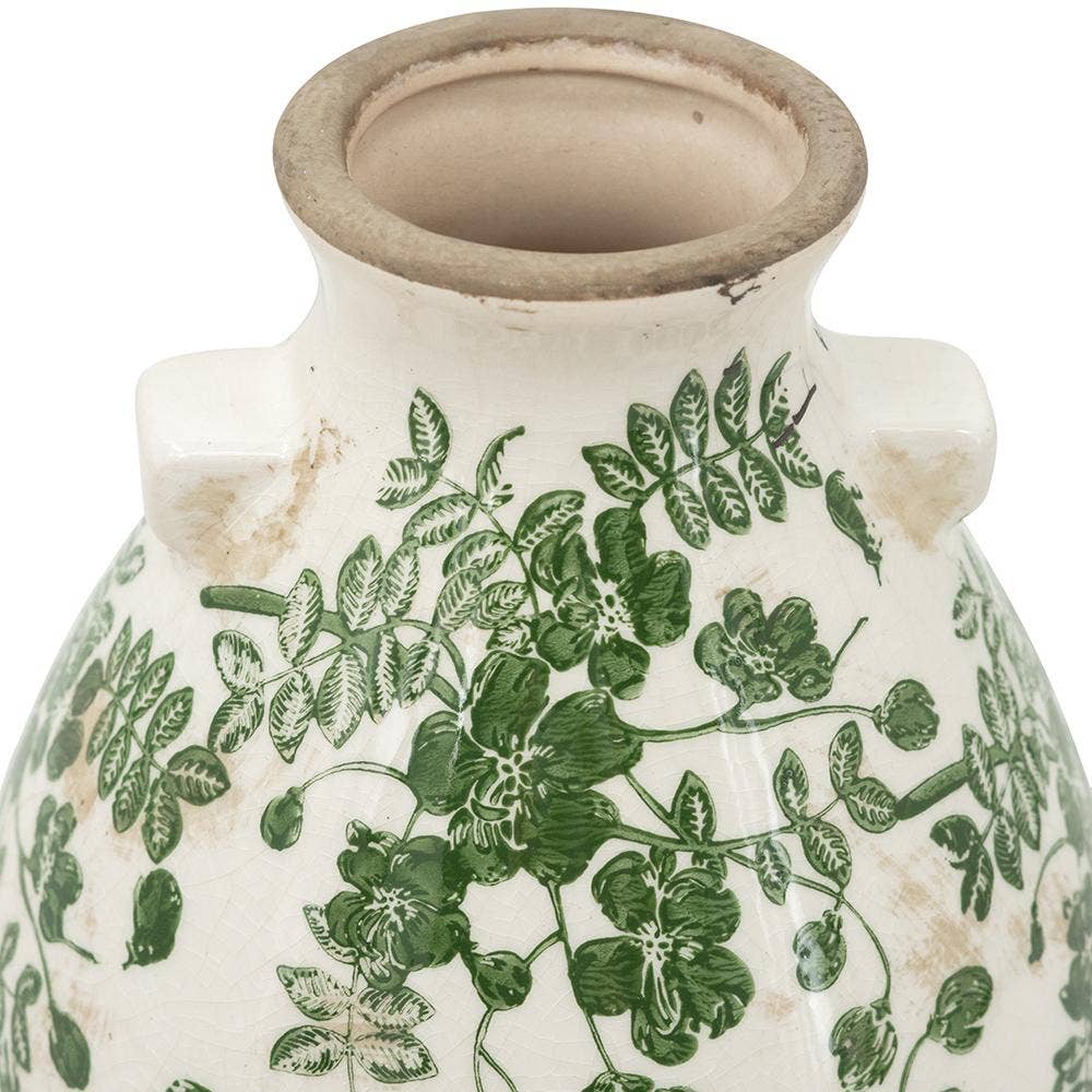 White ceramic vase with green floral patterns on a white background