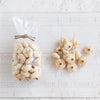 Bag of small pumpkins on a white textured surface