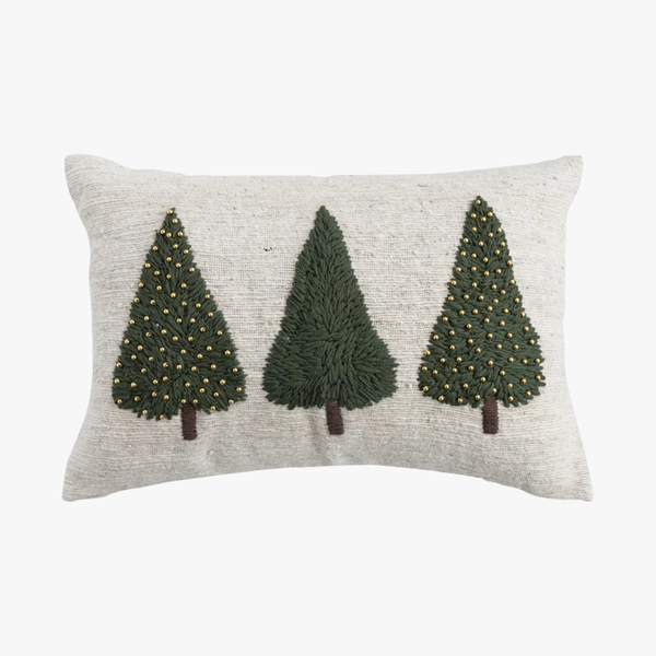 Decorative pillow with three green trees on a white background