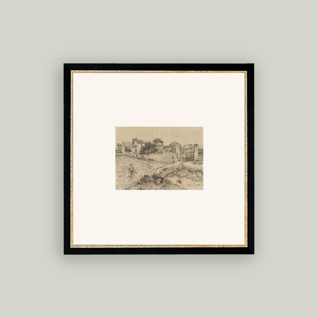 Framed artwork of a landscape with a black frame on a light gray wall