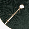 Dark green pleated Christmas tree skirt with gold decorative elements on a white background