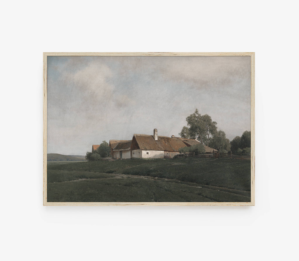 A framed landscape painting depicting a rural scene with a small white farmhouse, brown roof, green fields, and trees under a cloudy sky, shown against a light gray background.