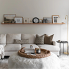 Cozy living room with a white sofa, coffee table, and decorative elements.