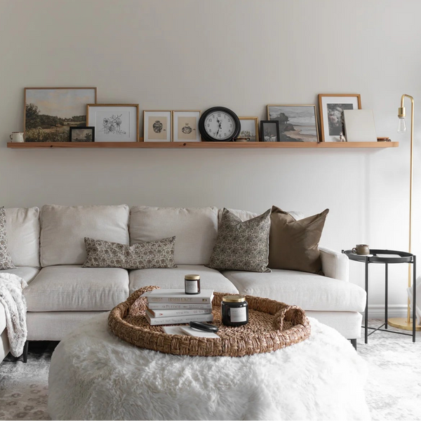 Cozy living room with a white sofa, coffee table, and decorative elements.