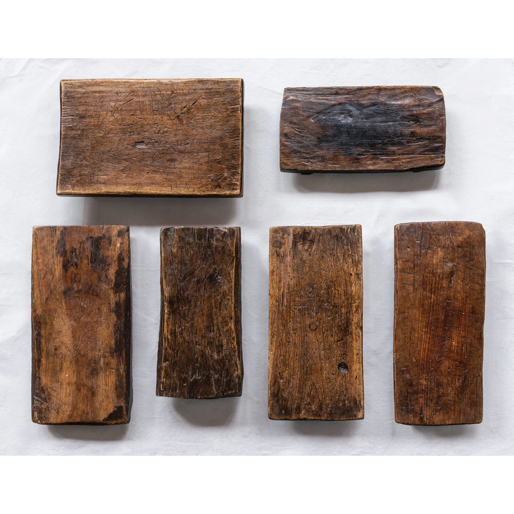 Set of six rustic wooden pedestal trays on a white background