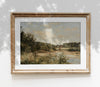 Framed landscape painting on a white wall