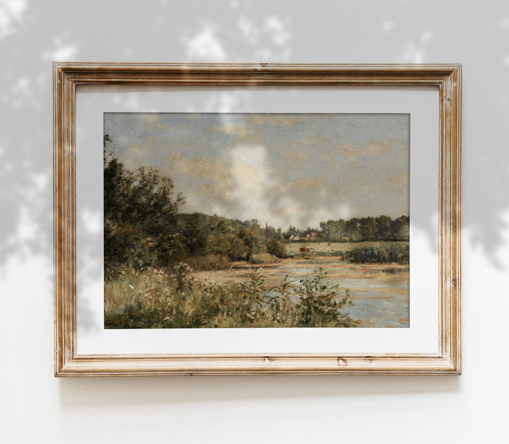 Framed landscape painting on a white wall