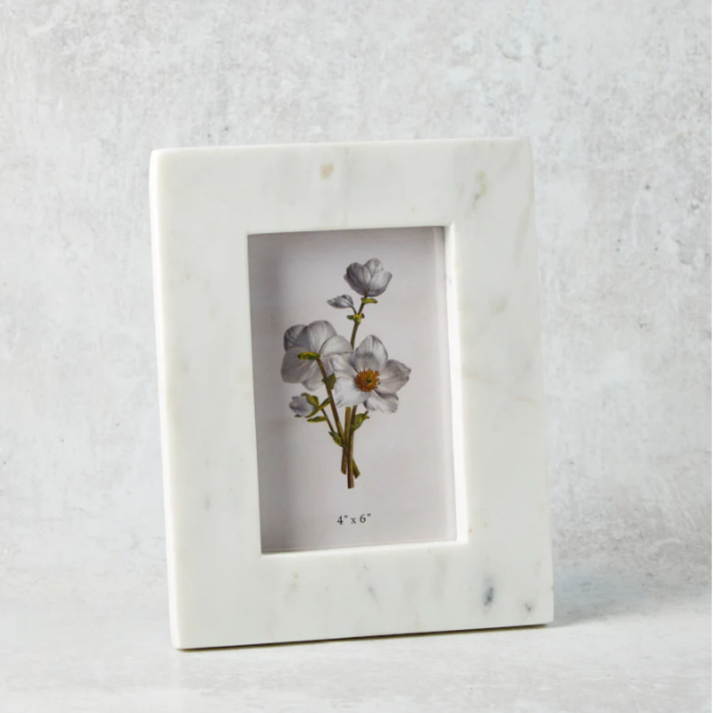 Marble-framed picture with floral illustration on a textured white background