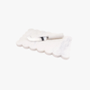 White scalloped cheese board with a cheese knife on a white background