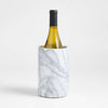 Marble-textured wine cooler with a bottle of white wine on a light gray background
