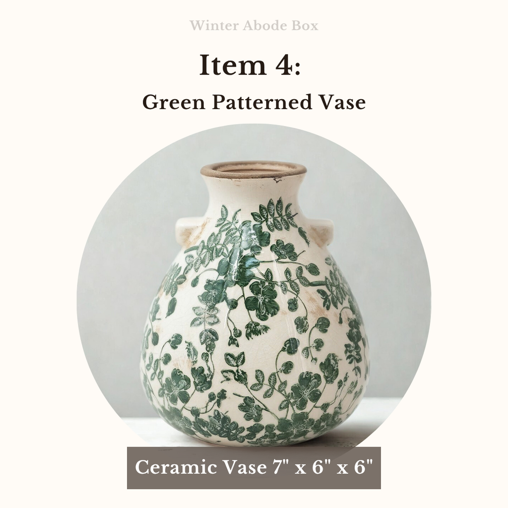 Ceramic vase with green patterns on a white background