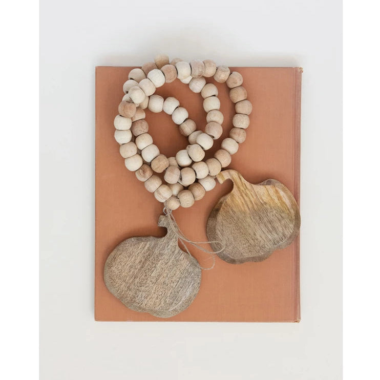 Wooden beads and decorative items on a brown card with a white background