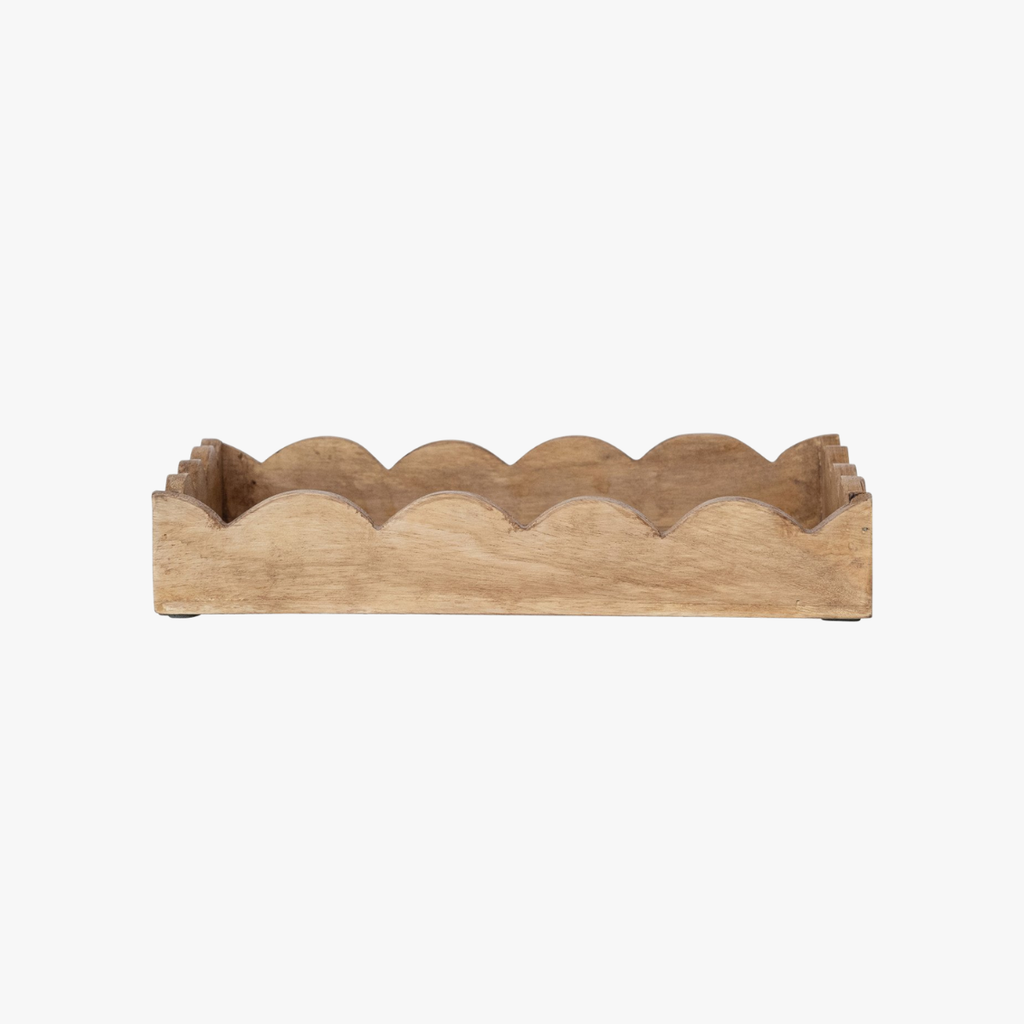 Wooden tray with scalloped edge on a white background