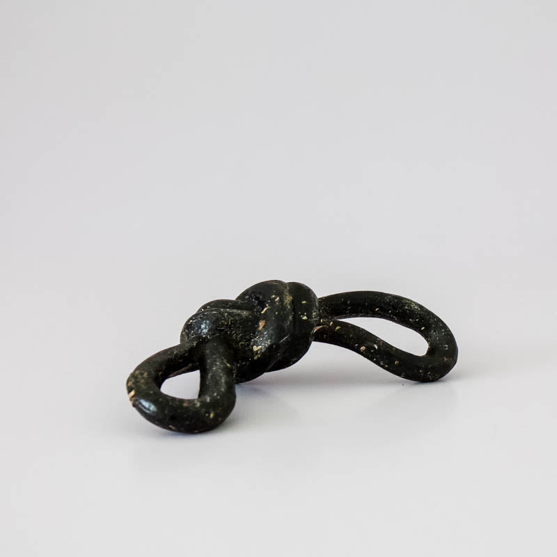 Black knot sculpture on a white background