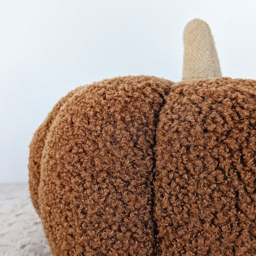 close up of a sherpa pumpkin pillow
