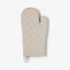Grey quilted oven mitt on a white background