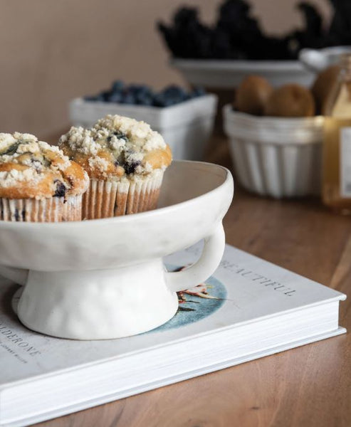 white stoneware bowl on kitchen counter with muffins