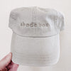 A beige twill cap with the brand name 'Abode Box' embroidered on the front.