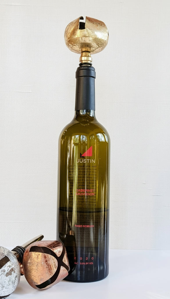Jingle Bell Wine Stopper with bottle of wine