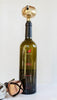 Jingle Bell Wine Stopper with bottle of wine