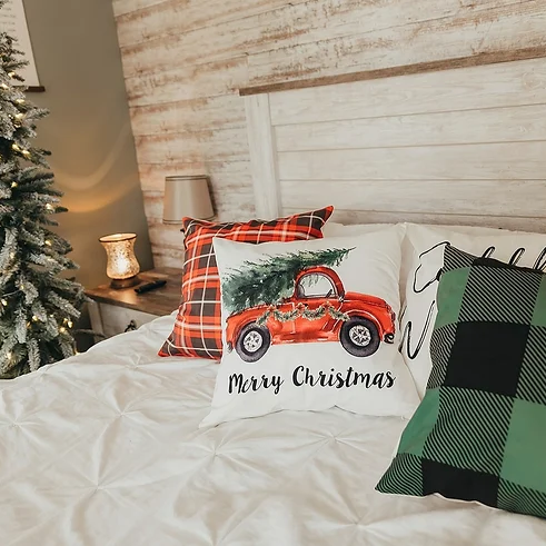 Red Truck Christmas Pillow Cover on bed with christmas decorations