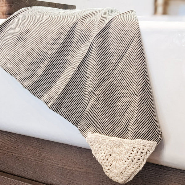 Black and white Stripe Tea Towel hanging over white farmhouse sink