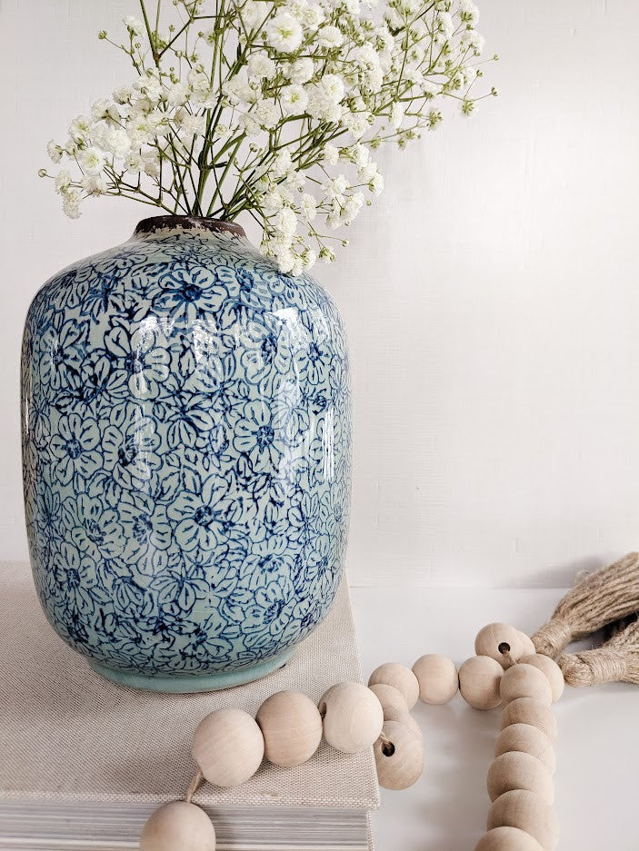 blue vase with white flowers
