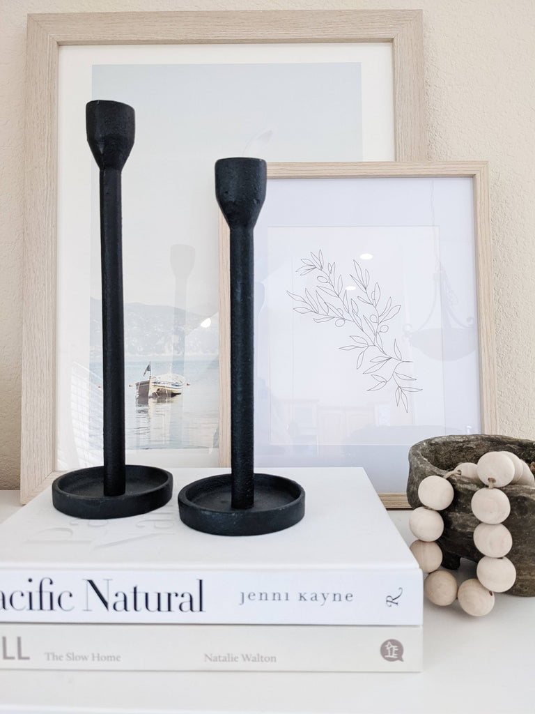 set of two modern black candle holders on coffee table book