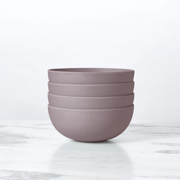 A gray bamboo salad bowl on a white marble surface.