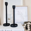 set of two modern black candle holders on coffee table book