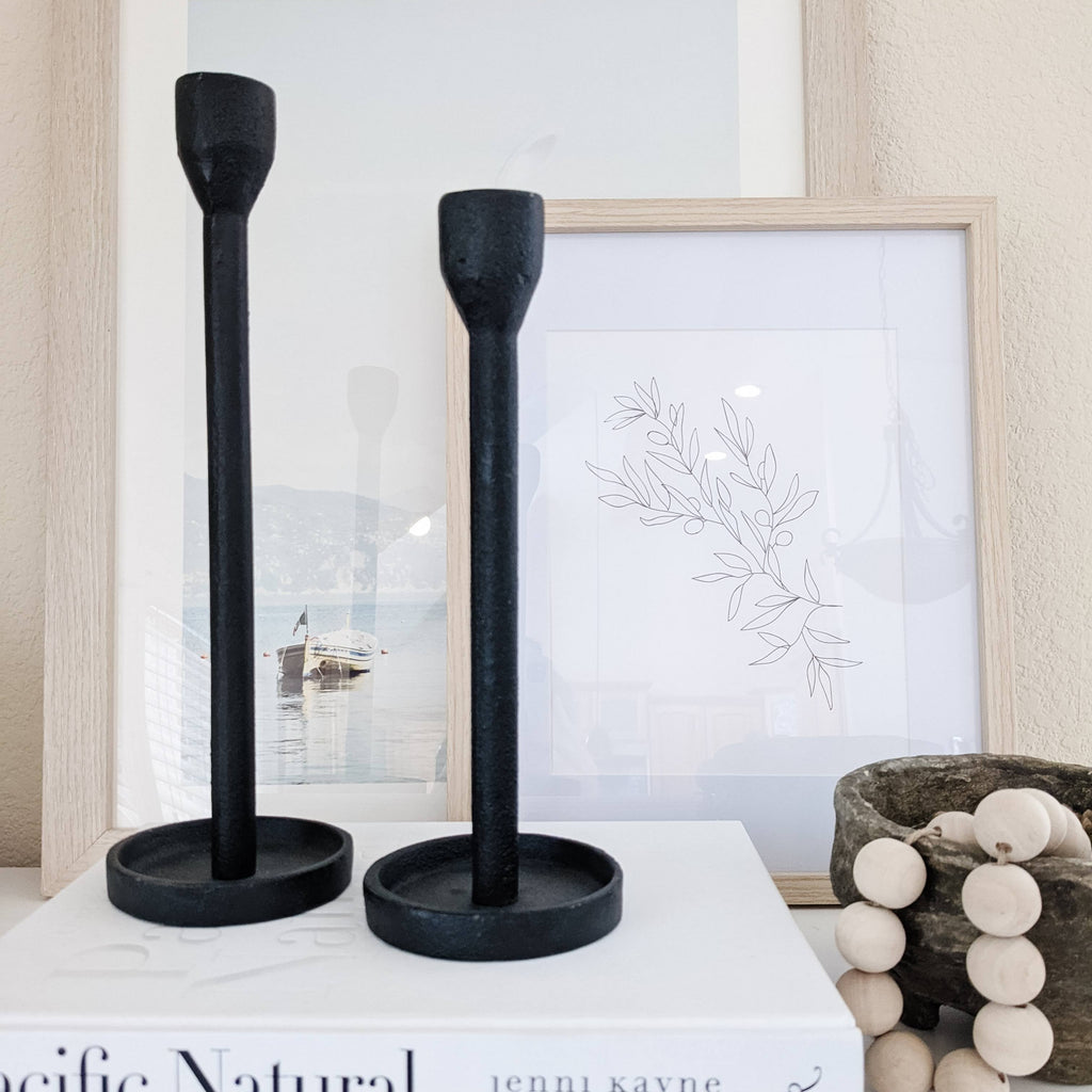 set of two modern black candle holders on coffee table book