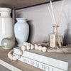wood beads with tassels on stylish bookcase